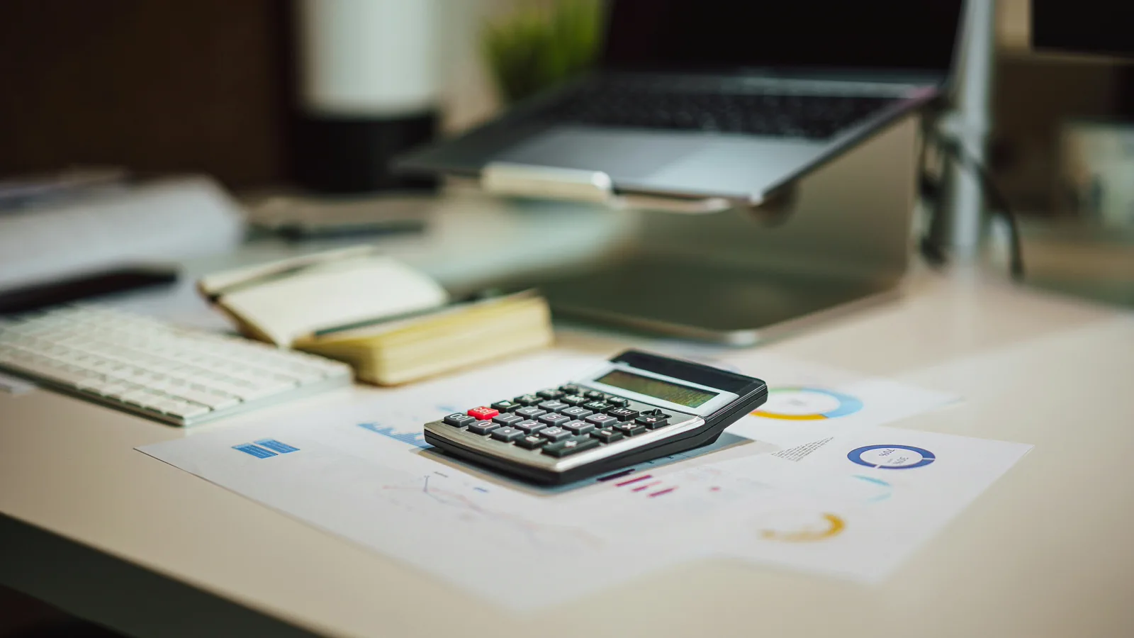Calculator and financial worksheets representing support calculations