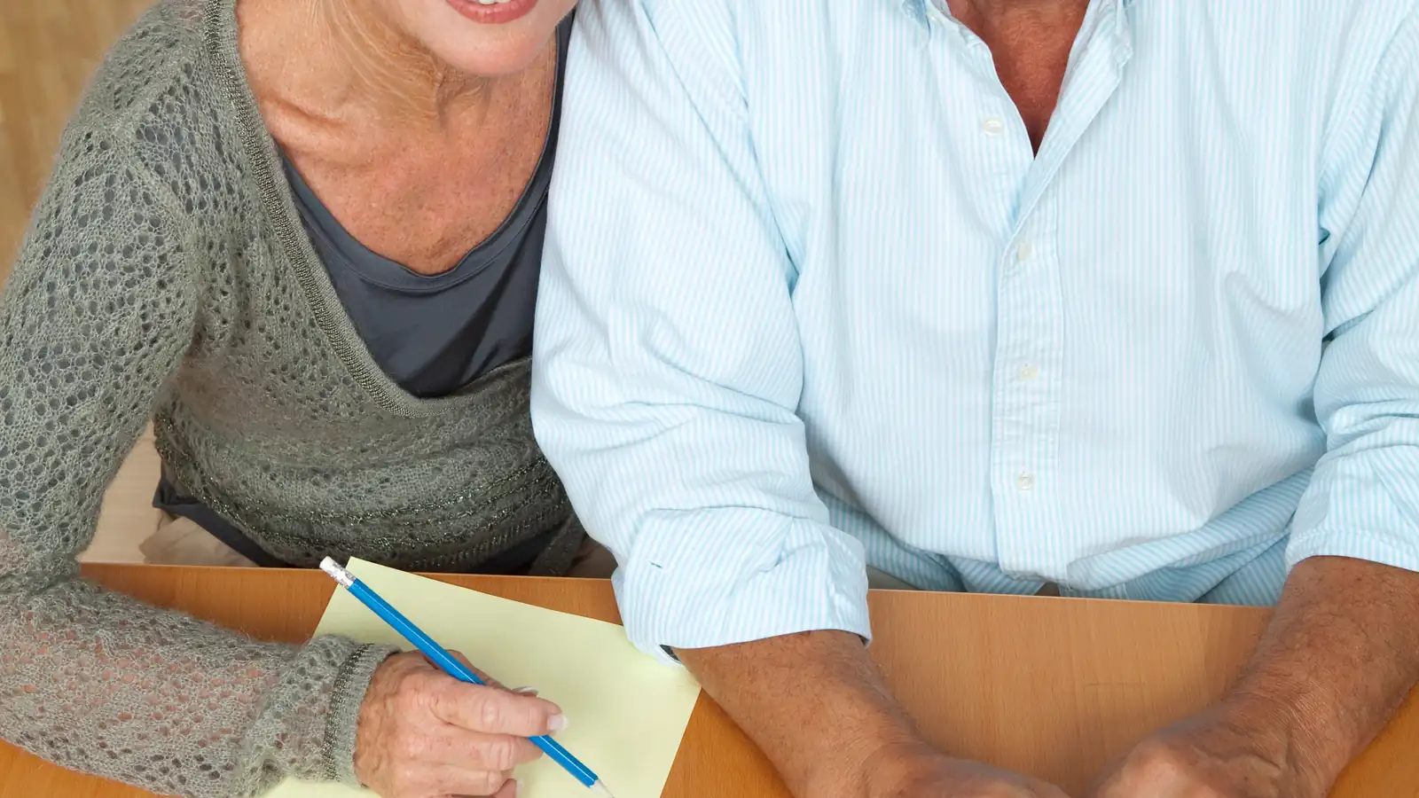 Mature couple reviewing figures together at a table